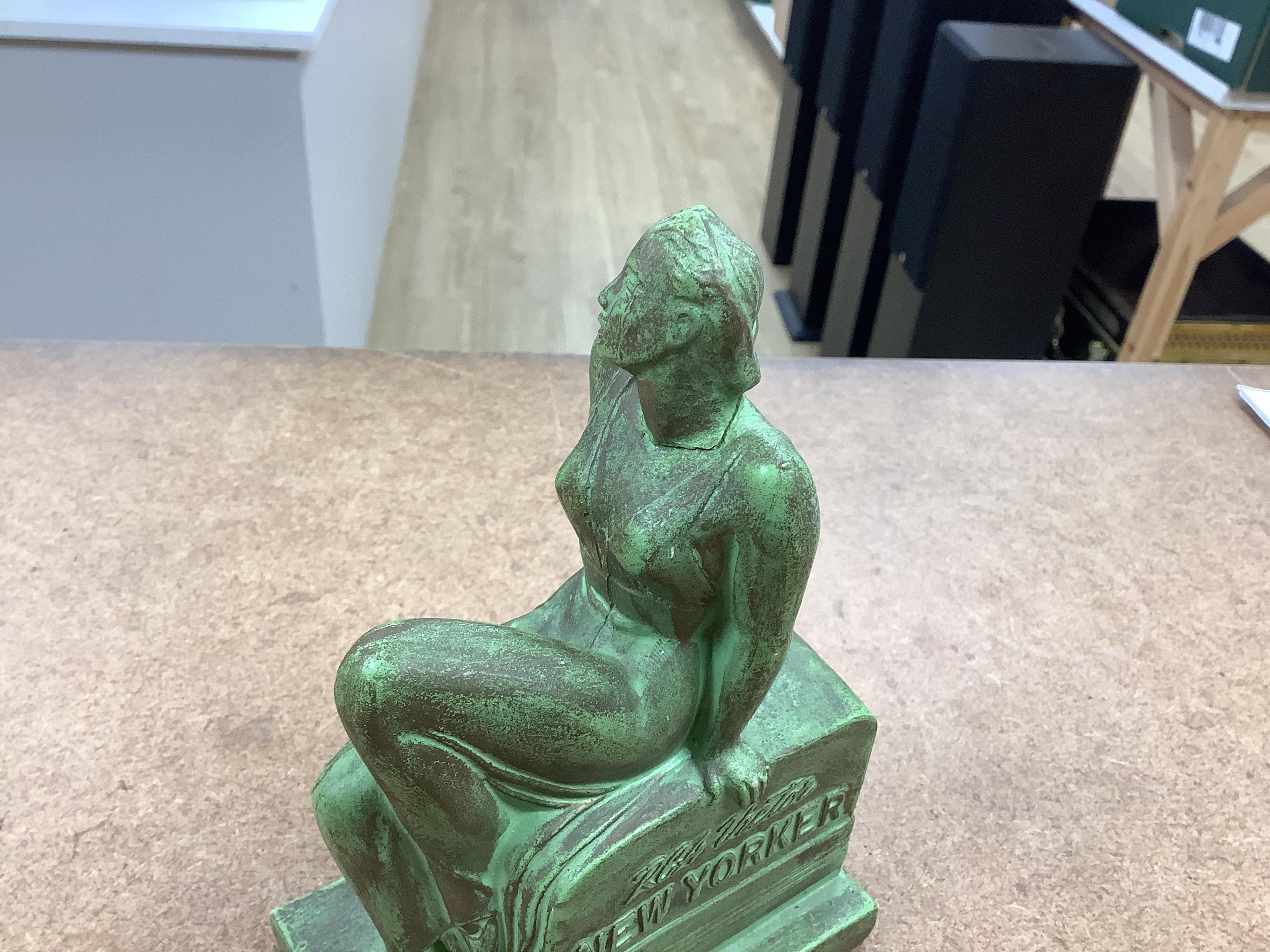 A pair of Art Deco RCA Victor bronzed ceramic ‘chalkwear’ bookends, in the form of a woman sitting on a 1930s radio, produced for the 1939 New York World Fair to promote the RCA Victor record label, 17cm high